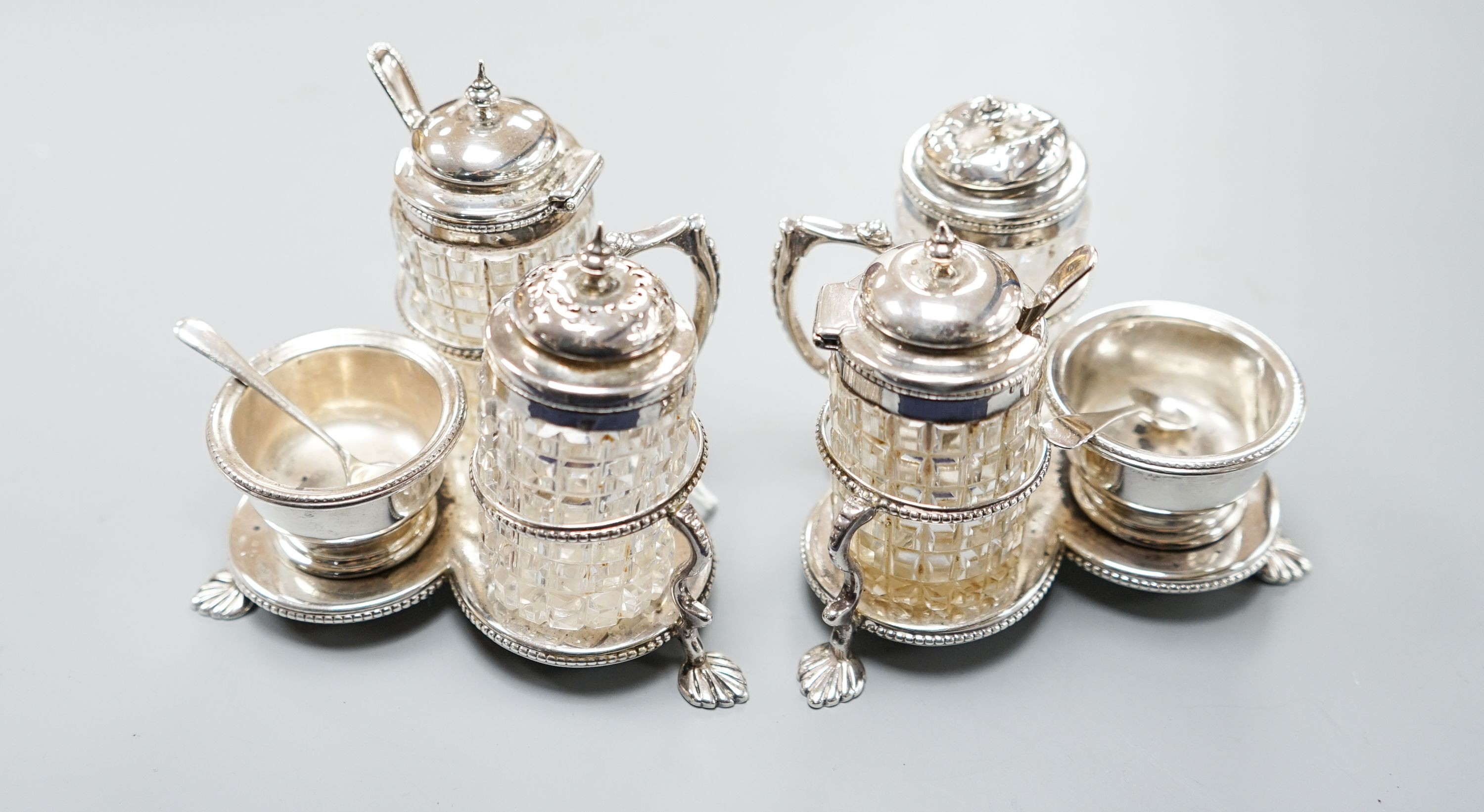 A pair of Victorian silver cruet stands, each with three cruets, Jane Brownett, London, 1880, height 85mm.